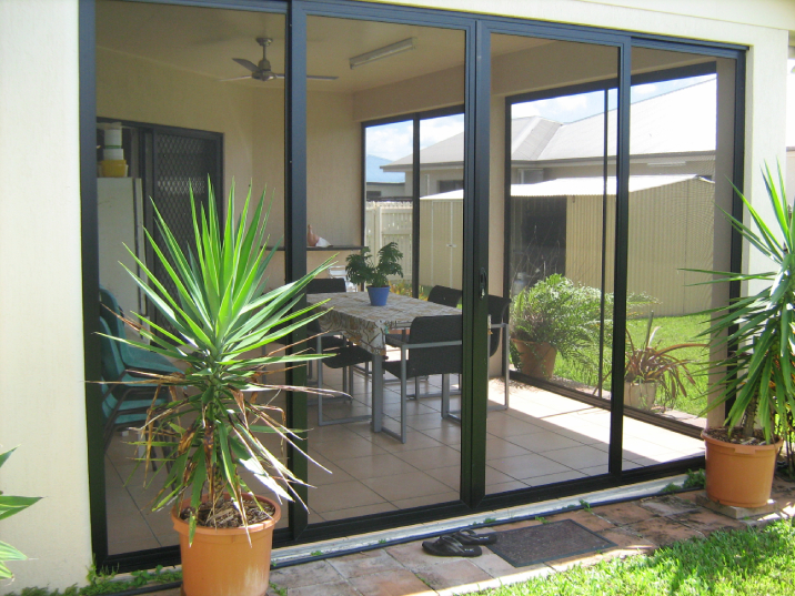 Aluminium door and windows opening to the backyard.