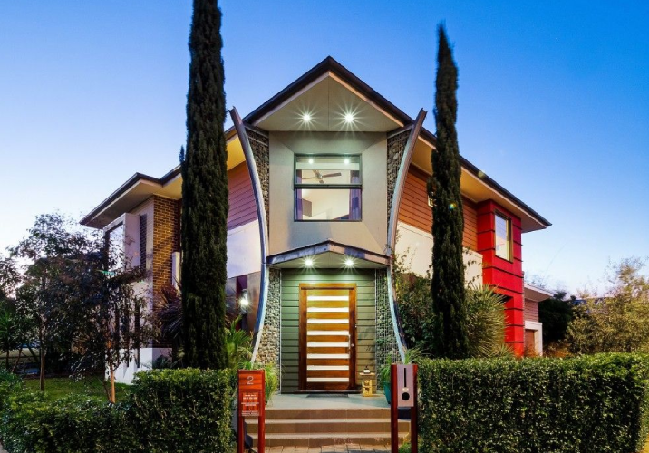 A two story house with a mutli coloured exterior